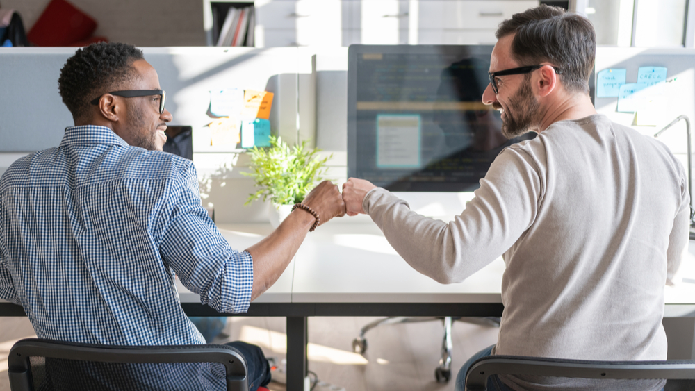 Fist bumping illustrating Nordic Partner Program