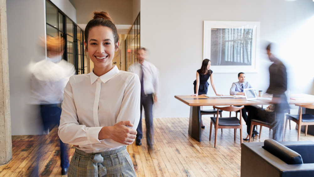 Office with blurry people and woman in front