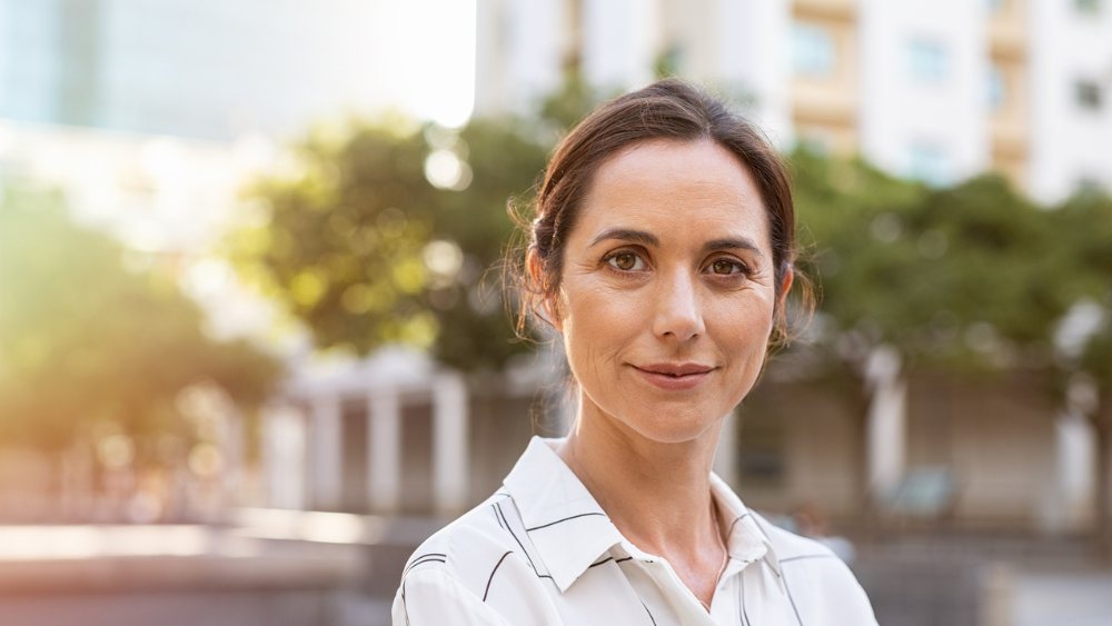 Successful mature woman looking at camera - stock photo