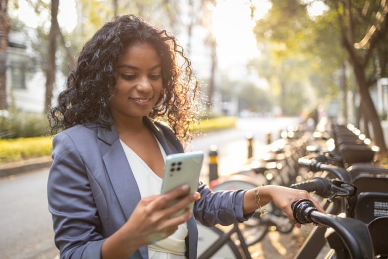 woman unlocking an e-bike with her smartphone