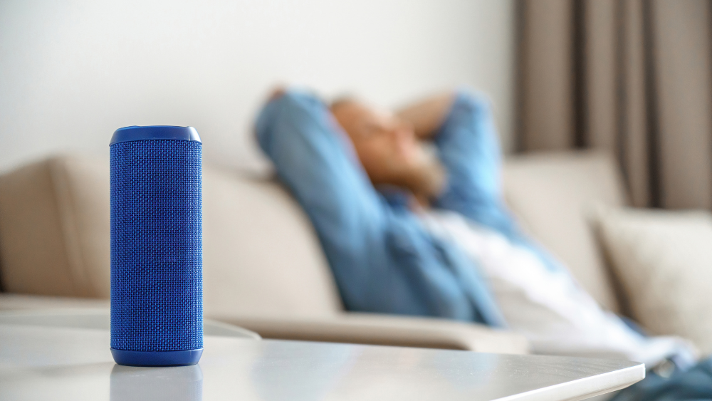 Man listening to Bluetooth speaker device