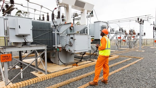person in high vis jacket working in substation