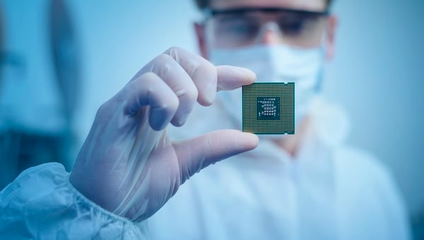 man holding computer chip