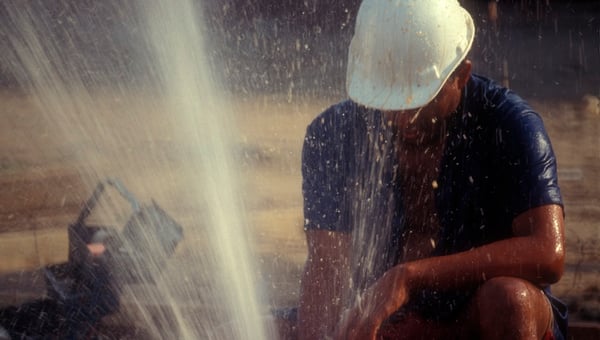 man working with water at a construction site